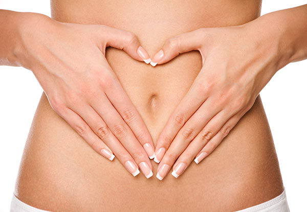 Hands forming a heart over the stomach area representing digestive comfort